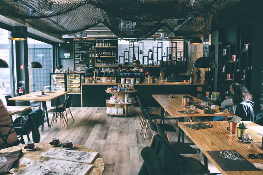Creative workspace with notebook, laptop, coffee and plants